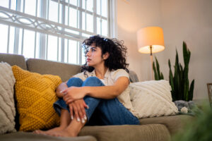 woman sitting on the couch anxious